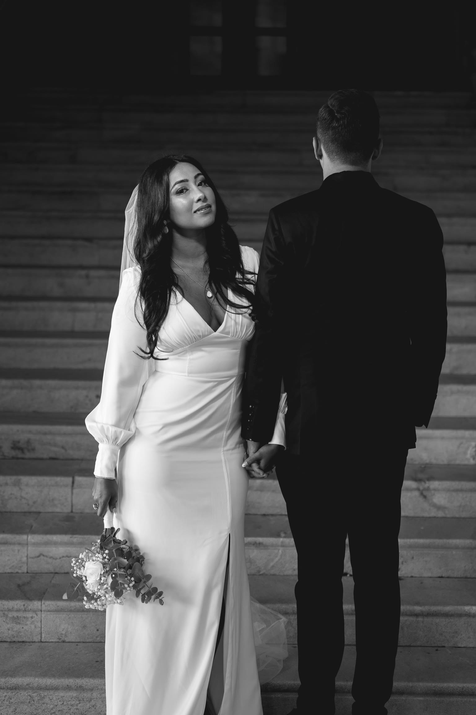 Bride and groom on the steps, black and white